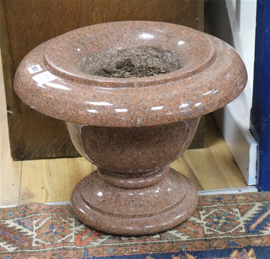 A pair of pink granite urns W.45cm